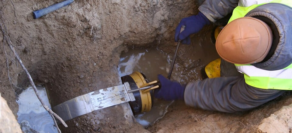 Plumber fixing a sewer pipe