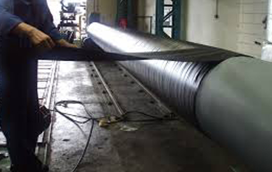 Man coating a pipe line