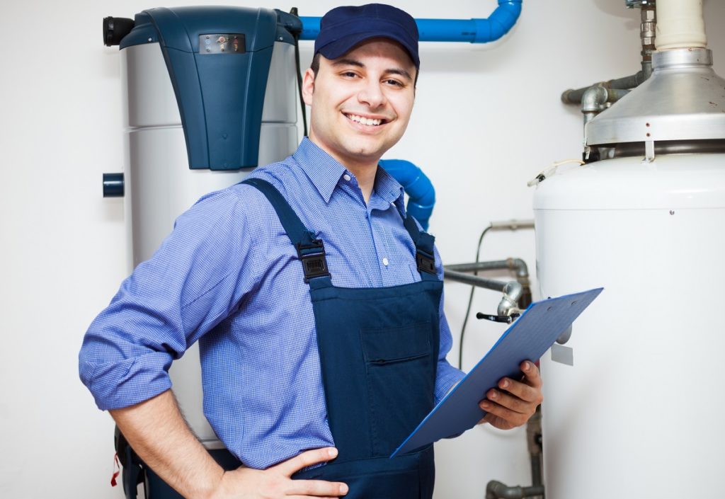 Plumber inspecting the water heater